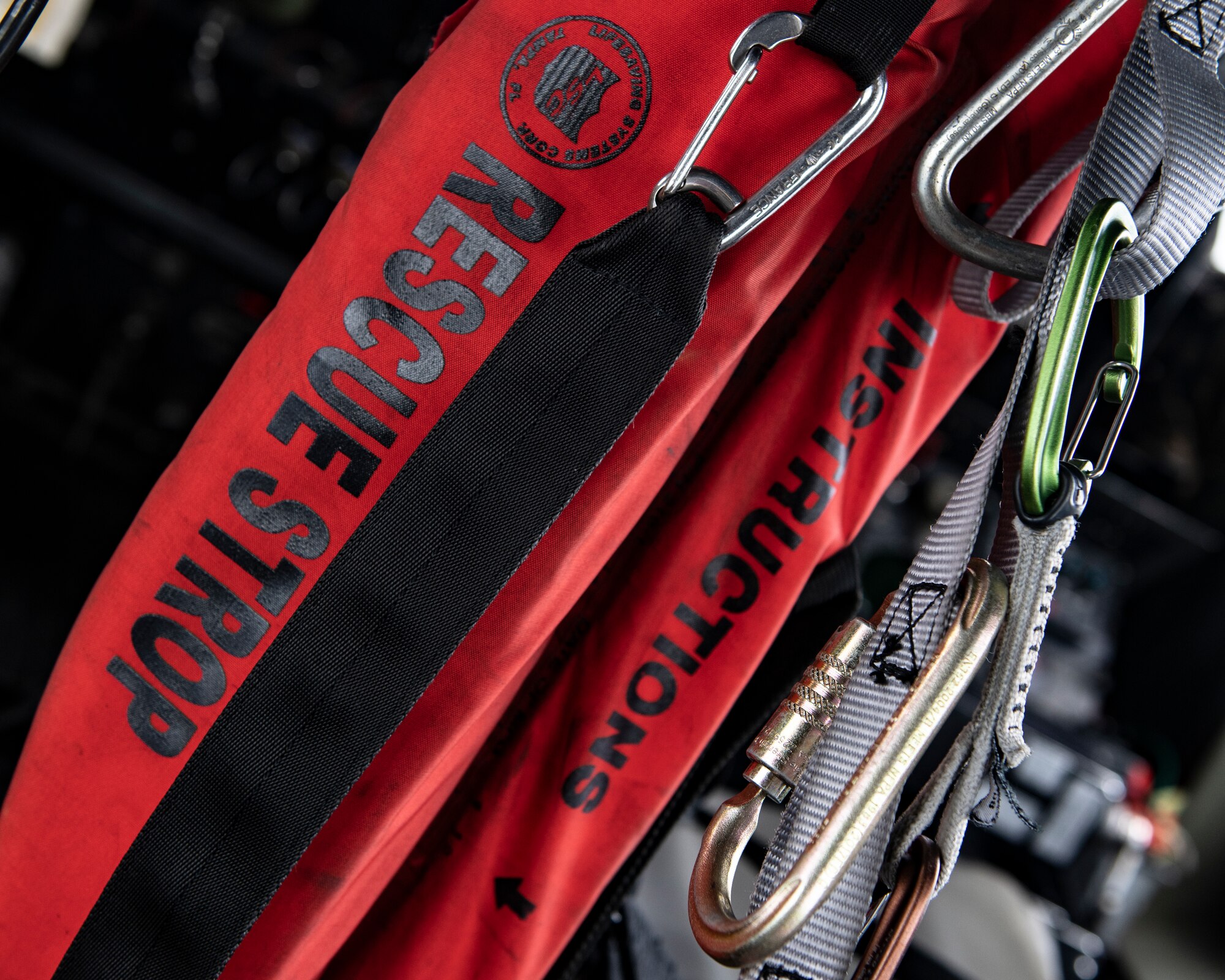 Rescue equipment hangs from carabiners inside of an HH-60G Pave Hawk assigned to the 33rd Rescue Squadron out of Kadena Air Base, Japan, Dec. 1, 2021. The Pave Hawk is equipped with a hoist capable of lifting up to 600 pounds during personnel recovery operations. (U.S. Air Force photo by Senior Airman Jessi Monte)