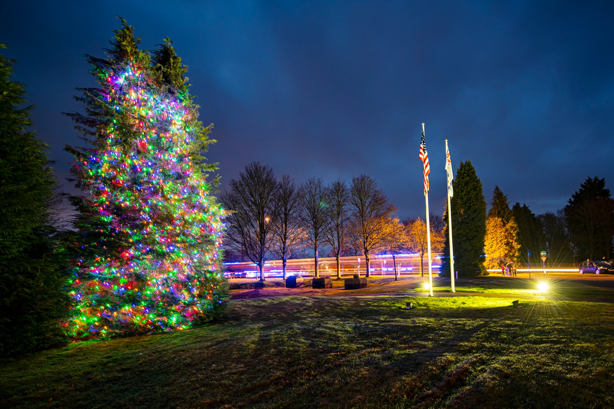 A tree is illuminated during a holiday tree lighting ceremony at RAF Croughton, England, Dec. 3, 2021. The 422d Air Base Group held a tree lighting ceremony and Christmas market that allowed Airmen and families to come together to celebrate the holiday season. (U.S. Air Force photo by Senior Airman Eugene Oliver)