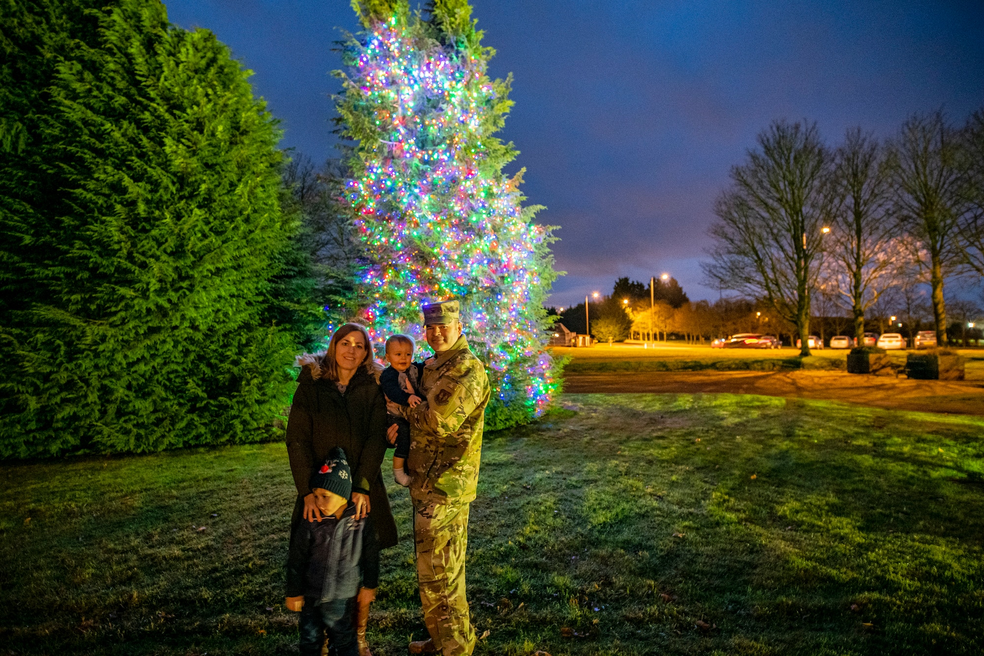 Col. Brian Filler, 501st Combat Support Wing commander, and his family pose for a photo at RAF Croughton, England, Dec. 3, 2021.  The 422d Air Base Group held a tree lighting ceremony and Christmas market that allowed Airmen and families to come together to celebrate the holiday season. (U.S. Air Force photo by Senior Airman Eugene Oliver)