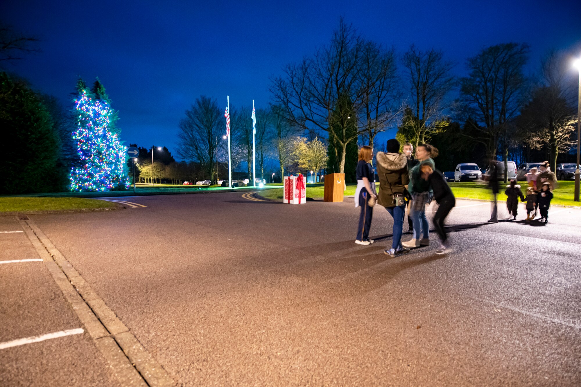 Airmen and families from the 501st Combat Support Wing attend a holiday tree lighting ceremony at RAF Croughton, England, Dec. 3, 2021. The 422d Air Base Group held a tree lighting ceremony and Christmas market that allowed Airmen and families to come together to celebrate the holiday season. (U.S. Air Force photo by Senior Airman Eugene Oliver)