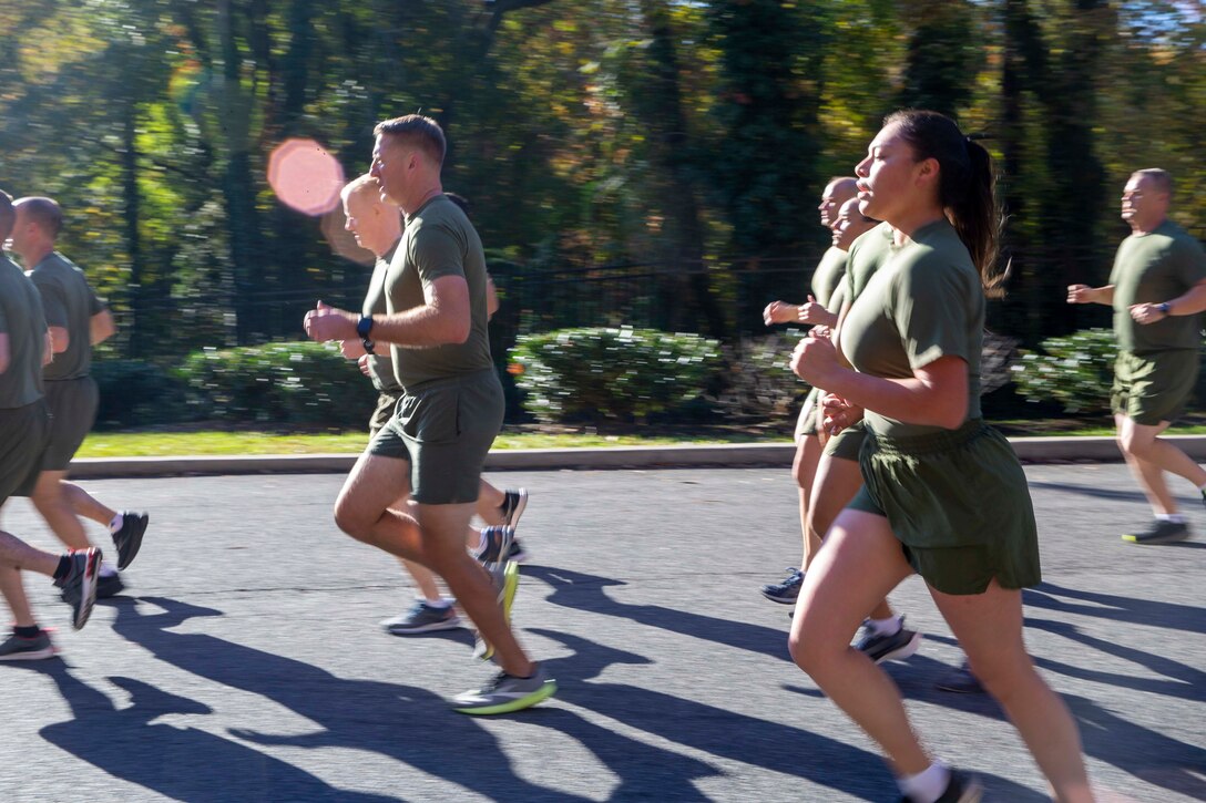 U.S. Marines with Headquarters Marine Corps and Headquarters Service Support Battalion call cadence during a formation run to the Marine Corps War Memorial in Arlington, Virginia, Nov. 9, 2021. The run was conducted in honor of the 246th Marine Corps birthday. A formation run is a traditional way units across the Marine Corps can celebrate the Marine Corps in addition to the cake cutting ceremony. (U.S. Marine Corps photo by Sgt. Victoria Ross)