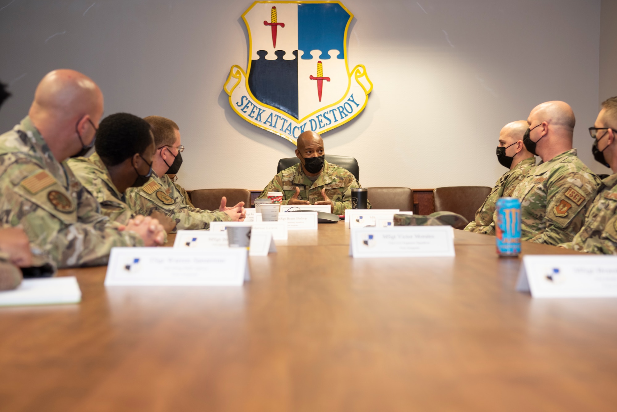 U.S. Air Force Chief Master Sgt. Mike Perry, Air Force first sergeant special duty manager, center, gathers with 52nd Fighter Wing first sergeants in a conference room, Dec. 2, 2021, on Spangdahlem Air Base, Germany. First sergeants are dedicated focal points for all readiness, health, morale, welfare and quality of life issues within their organizations. At home station and in expeditionary environments, their primary responsibility is to build and maintain a mission-ready force. (U.S. Air Force photo by Airman 1st Class Marcus Hardy-Bannerman)