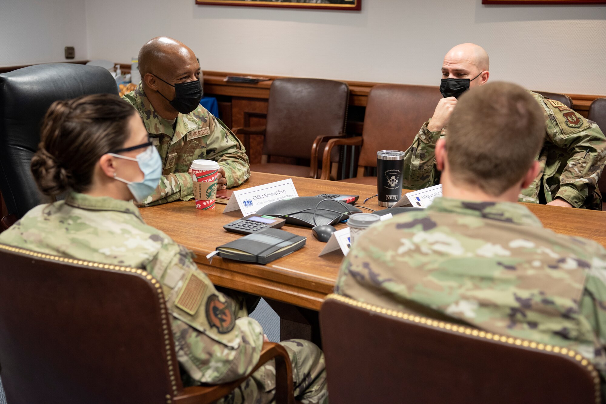 U.S. Air Force Chief Master Sgt. Mike Perry, Air Force first sergeant special duty manager, far left, engages in conversation with 52nd Fighter Wing first sergeants in a conference room, Dec. 2, 2021, on Spangdahlem Air Base, Germany. Perry accompanied Chief Master Sgt. of the Air Force JoAnne S. Bass on her visit to the 52nd Fighter Wing, to get insight on the mission and well-being of Airmen and their families. (U.S. Air Force photo by Airman 1st Class Marcus Hardy-Bannerman)