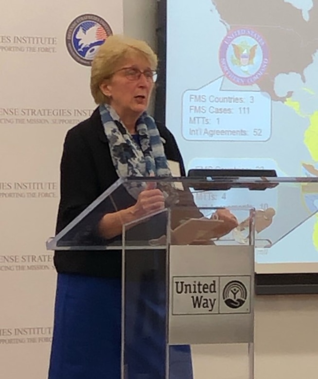 Sandy Long, Senior Advisor for Defense Exports in the Office of the Deputy Assistant Secretary of the Army for Defense Export and Cooperation, speaks at the inaugural Military Wheeled Vehicles Systems Summit in Alexandria, Va., Dec. 1, 2021.