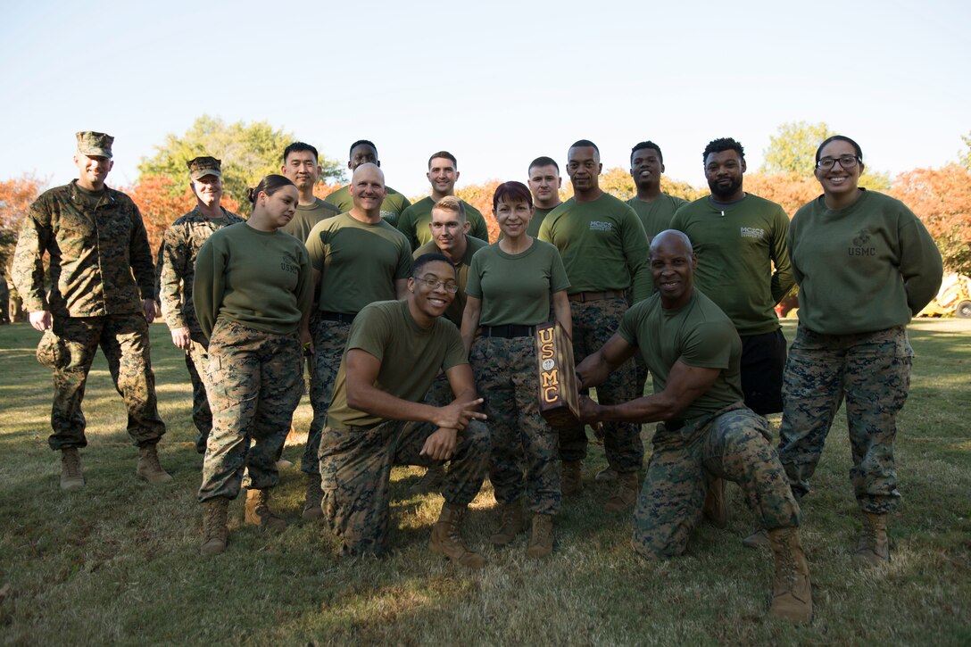 U.S. Marines with Fleet Marine Force, Atlantic (FMFLANT), Marine Forces Command (MARFORCOM), Marine Forces Northern Command (MARFORNORTH), pose for a group photo as the winners of a competition during a command field meet at Naval Support Activity Hampton Roads, Norfolk, Virginia, Nov. 9, 2021. In celebration of the 246th Marine Corps Birthday, sections of FMFLANT, MARFORCOM, MARFORNORTH competed in challenges to test their mental and physical abilities and build camaraderie. Lt. Gen. John A. Lejeune, 13th Commandant of the Marine Corps, issued an order to formalize the tradition and establish Nov. 10 as the official day of the Marine Corps birthday. (U.S. Marine Corps photo by Lance Cpl. Jack Chen)