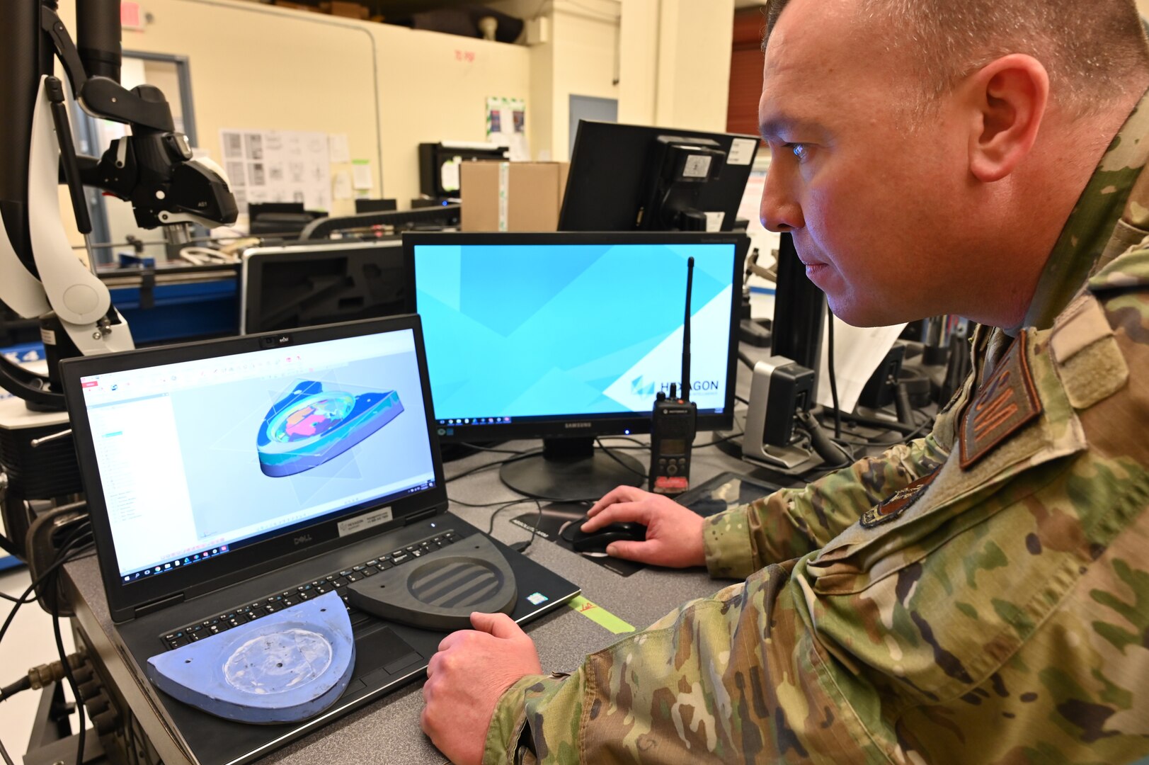 U.S. Air Force Master Sgt. Paul Allen, a structural maintainer with the 173rd Fighter Wing, uses modeling software and a scanning camera to replicate the plaster mold on his left at Kingsley Field in Klamath Falls, Ore., Nov. 11, 2021.
