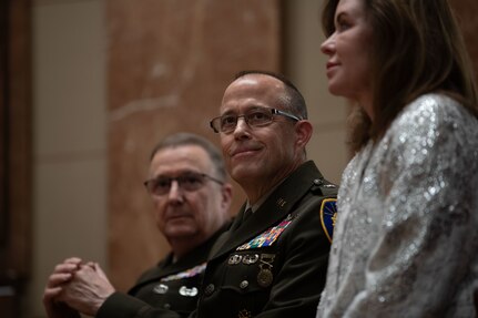 Timothy J. Winslow, a Shelbyville native, sits between Brig. Gen. Dale Lyles, the adjutant general of Indiana and his wife, Dr. Catherine Winslow, at the Indiana War Memorial in Indianapolis, Saturday, Dec. 4, 2021. The Indiana National Guard promoted Winslow to the rank of major general, and he will serve as an assistant adjutant general.