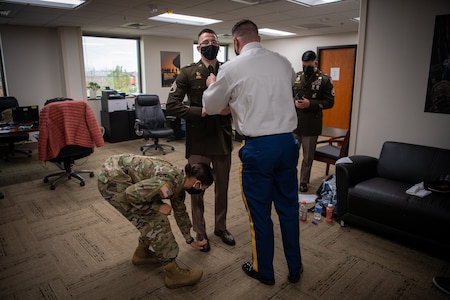 Soldiers assisting each other to get ready.