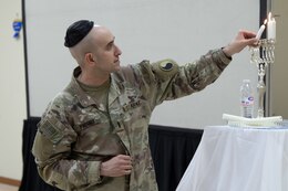 Soldier lights menorah