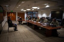 Soldier sits in front of board members.