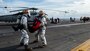 Sailors carry a simulated patient during a mass casualty drill on the flight deck of the Nimitz-class aircraft carrier USS Carl Vinson (CVN 70).
