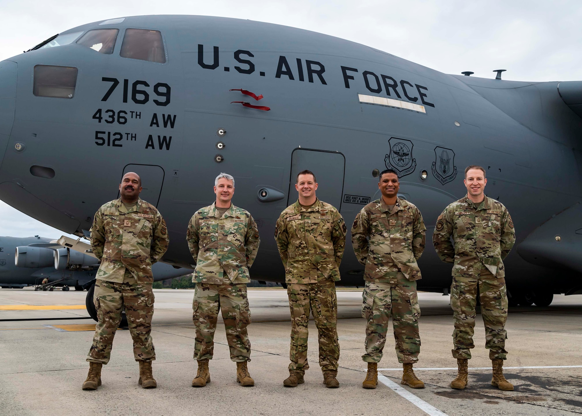 From left, Senior Master Sgts. Daniel Hall, 436th Operational Support Squadron aircrew flight equipment superintendent, Andrew Casper, 736th Aircraft Maintenance Squadron aircraft maintenance unit superintendent, Richard Brownlee, 3rd Airlift Squadron senior enlisted leader, Troy Sahai, 436th Airlift Wing wing staff agency superintendent, and Adam Jensen, 436th Communications Squadron senior enlisted leader, pose for a photo in front of a C-17 Globemaster III at Dover Air Force Base, Delaware, Dec. 2, 2021. The Airmen are Dover AFB’s newest chief master sergeant selects. (U.S. Air Force photo by Senior Airman Stephani Barge)