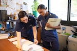 Coast Guard members reviewing paperwork