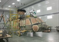 A Corpus Christi Army Depot painter journeyman applies the new “Class N” primer undercoat to the first Army Black Hawk helicopter.