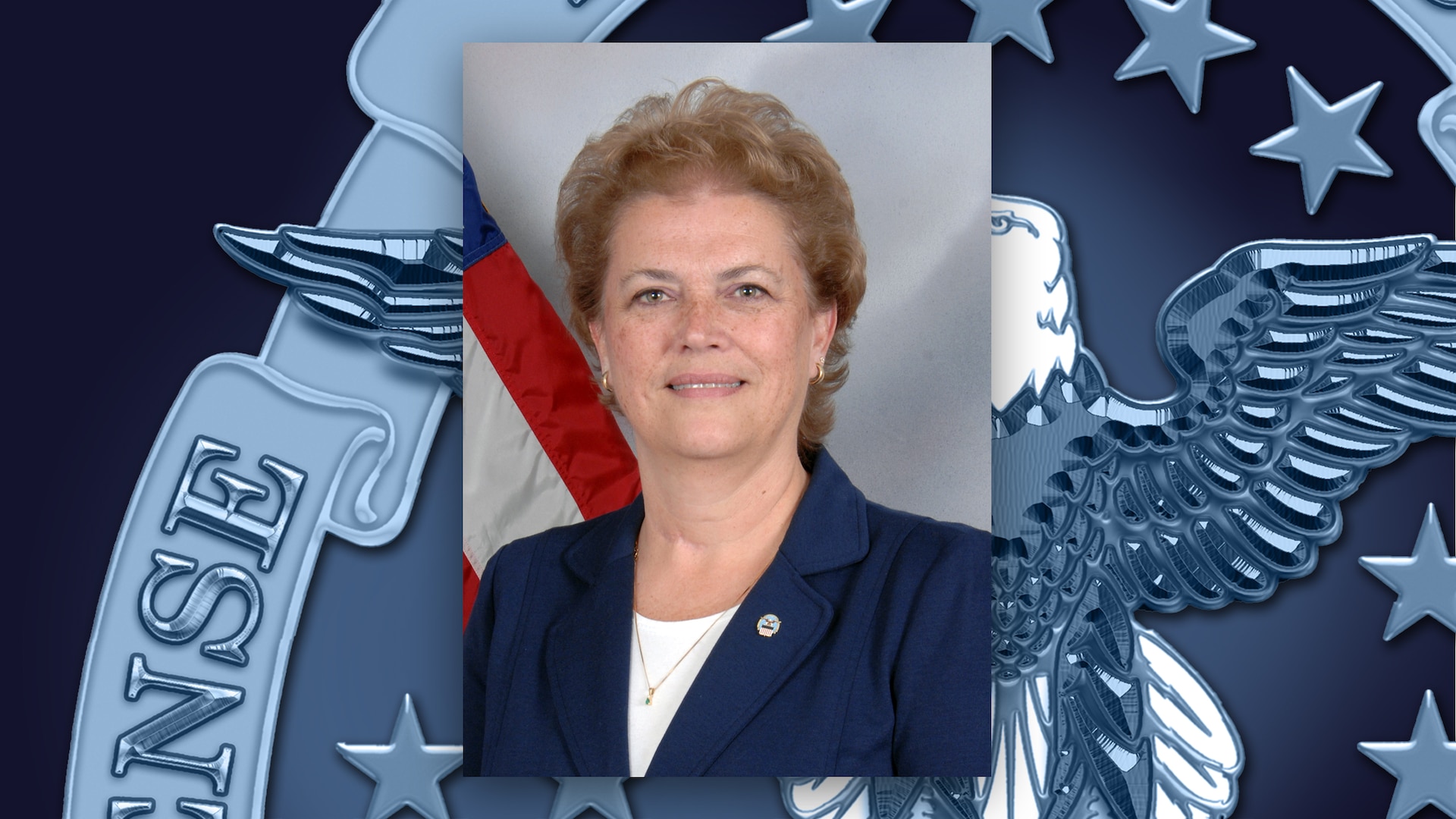 Head and shoulders shot of a woman in a white shirt and blue jacket.