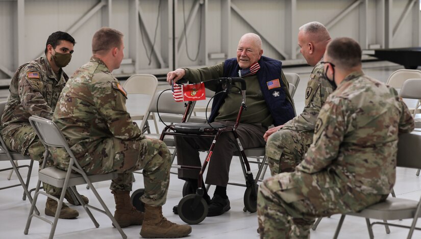 Sayre Christian village resident Paul Frederick talks with 63rd TAB Soldiers before award ceremony at the Army Aviation Support Facility hanger on Boone National Guard Center Dec. 2. The Soldiers were awarded the LeadingAge Kentucky Distinguished Service Award and the Guardian Angel Award for their work completed during the pandemic. (US Army National Guard Photo by Mrs. Jesse Elbouab)