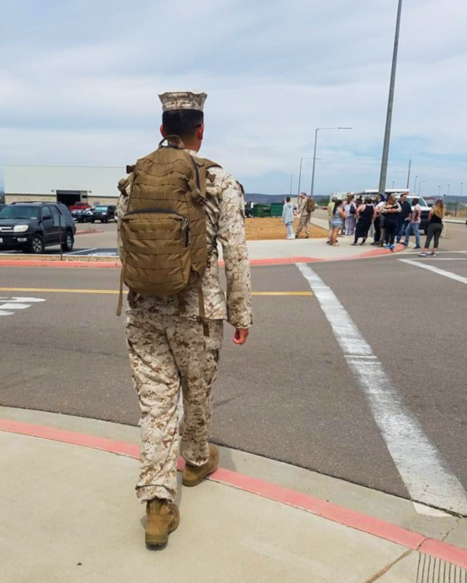 Then, U.S. Marine Corps Lance Cpl. Gerardo Verdugo, fixed-wing crew chief, walks towards a tram on Marine Corps Air Station Miramar, Calif., July 25, 2016. Verdugo deployed in support of the Special Purpose Marine Ground Task Force. (U.S. Space Force photo by Airman 1st Class Dakota Raub)