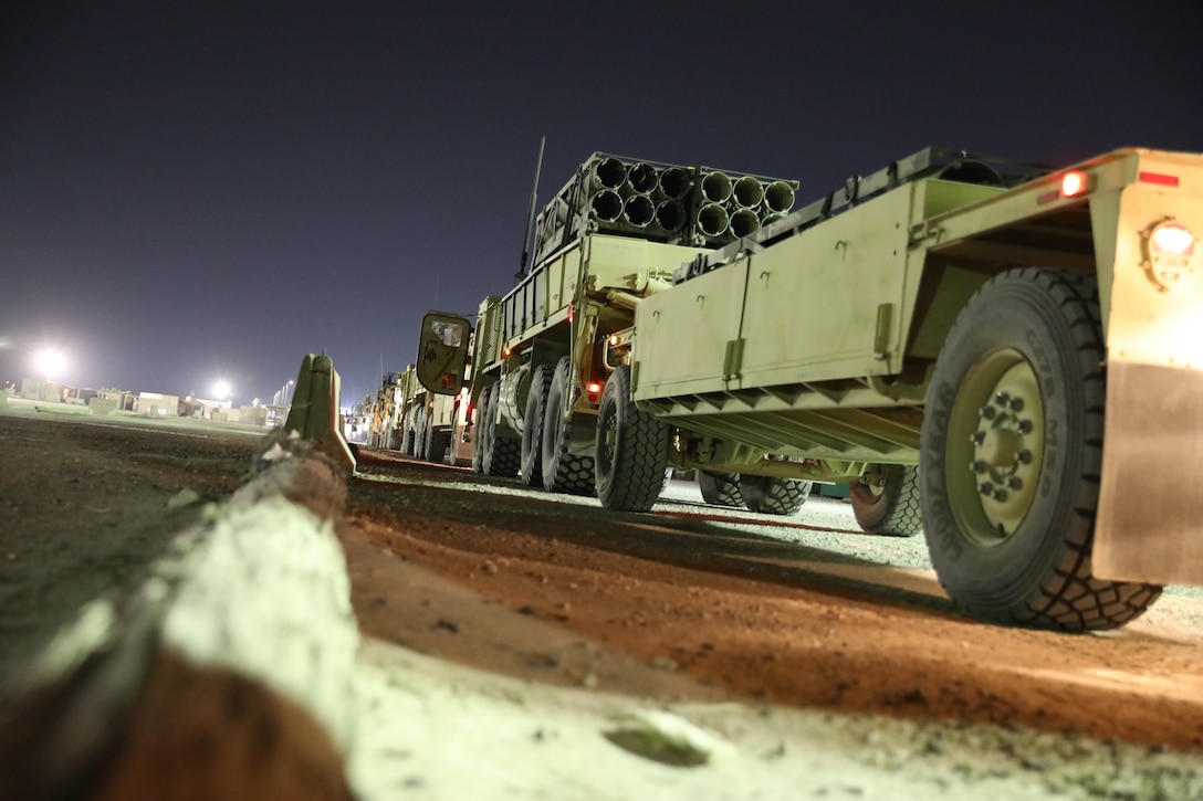 Military vehicles are lined up in a convoy.