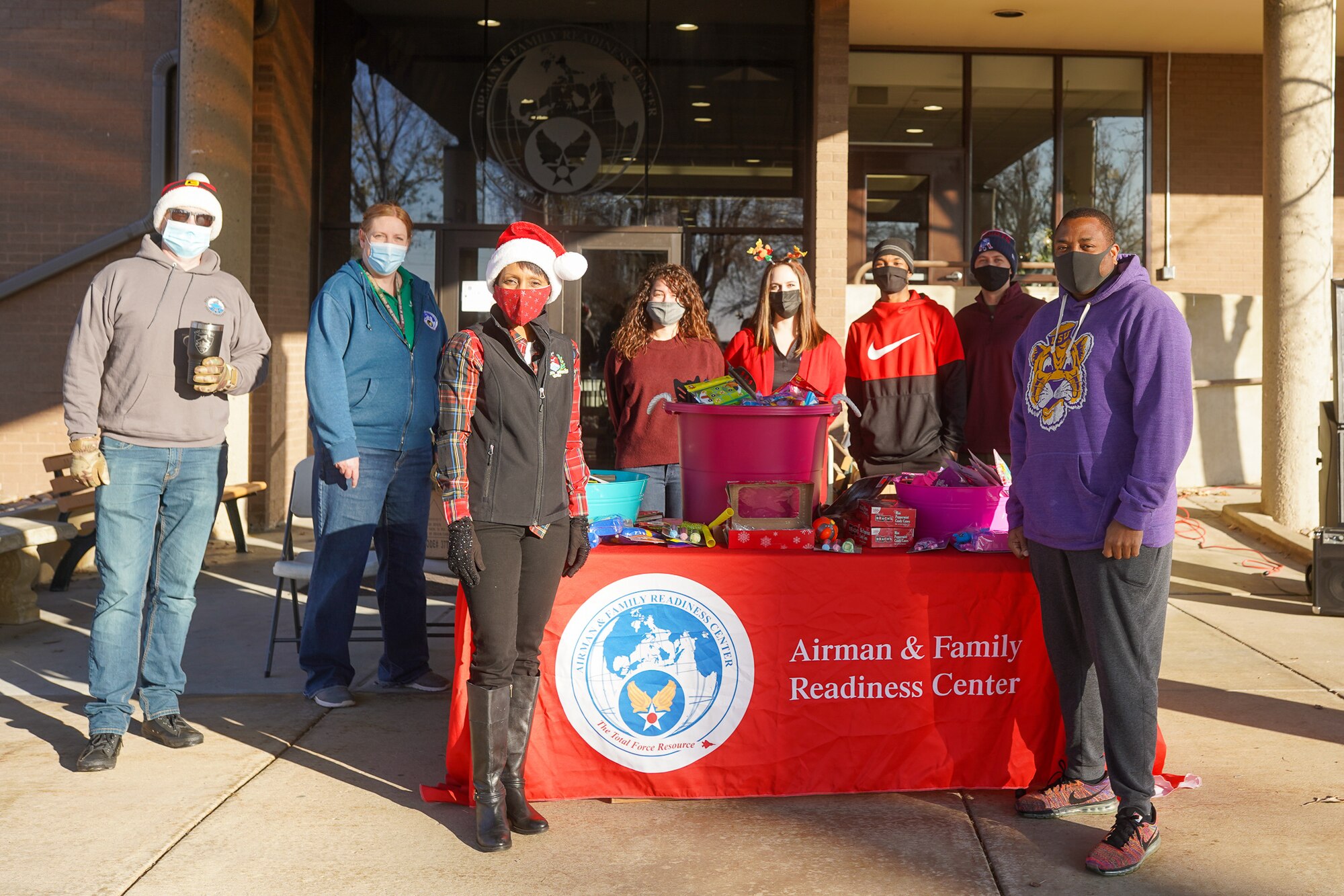 Col. Jenise Carroll (left), 75th Air Base Wing commander, and Chief Master Sgt. Raymond Riley (right), 75th ABW command chief, pose for a photograph with volunteers during a Christmas tree giveaway event at Hill Air Force Base, Utah, Dec. 4, 2021. Trees for Troops, a program of the Christmas SPIRIT Foundation, provided live Christmas trees to 150 service members and their families with the help of volunteers from Hill AFB. (U.S. Air Force photo by 2nd Lt. Taylor Ferry)
