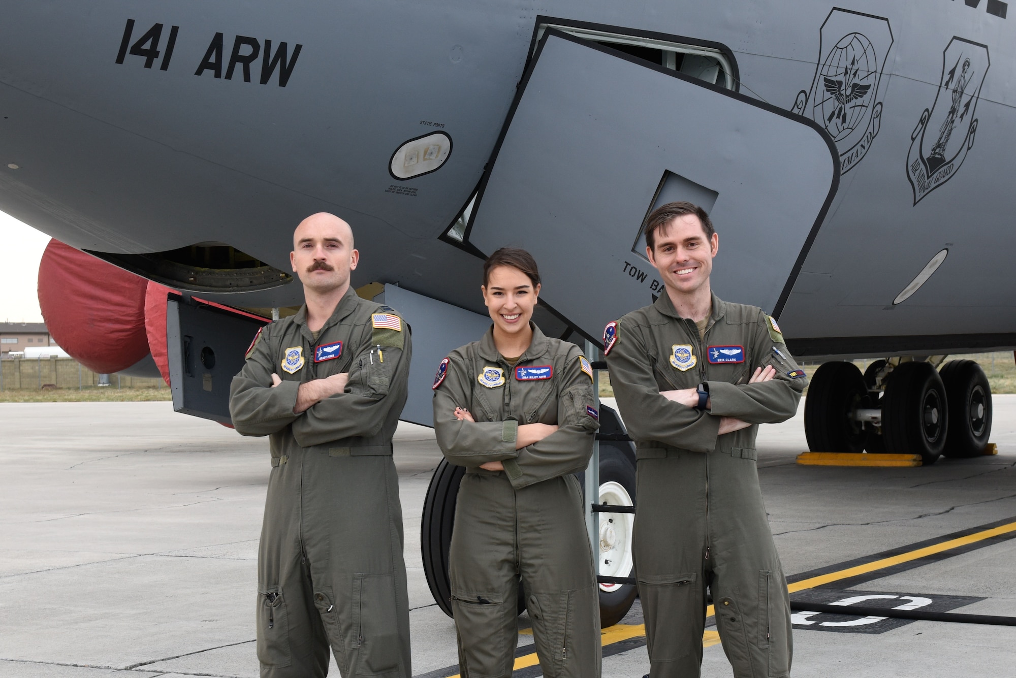 U.S. Air Force Capt. Erik Clark, 93rd Air Refueling Squadron KC-135 Stratotanker instructor pilot, Capt. Brady Miner, 93rd ARS KC-135 co-pilot, and Senior Airmen Riley Shin, 93rd ARS boom operator pose in front of a KC-135 at Fairchild Air Force Base, Washington, Dec. 2, 2021. Their crew received the task to evacuate nearly 20 refugees at a location only their aircraft could land during Operation Allies Refuge. (U.S. Air Force photo by Airman Jenna A. Bond)