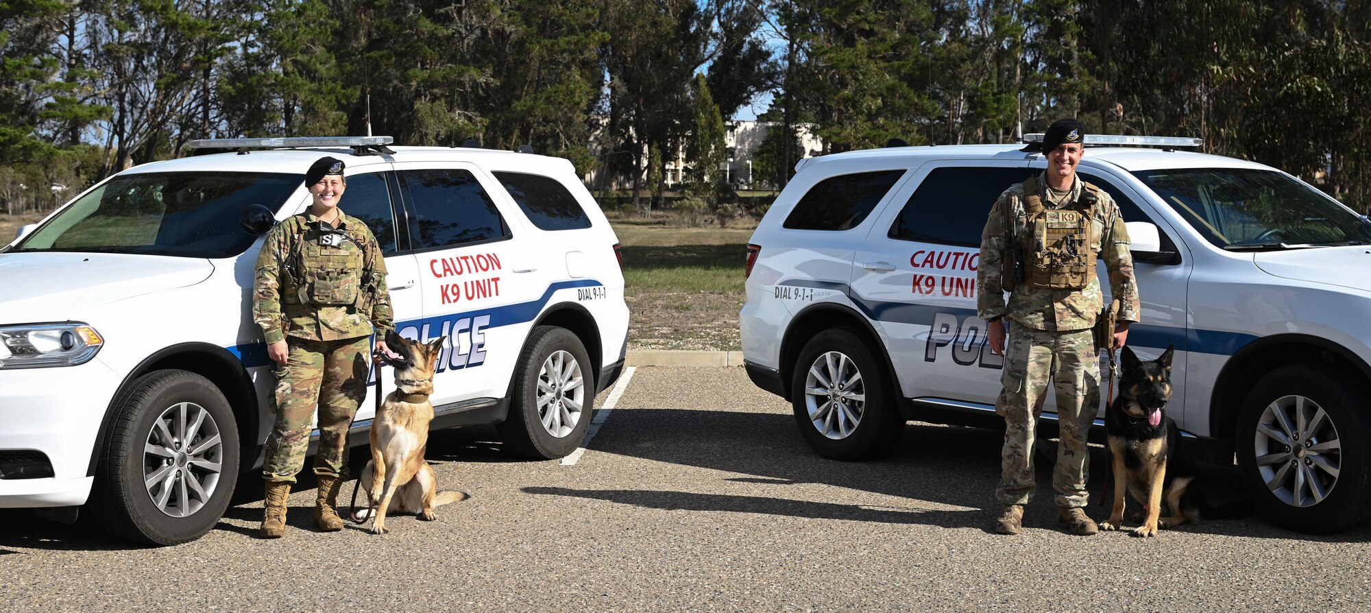 Staff Sgt. Anna Barry, 30th Security Forces Squadron military working dog handler, with MWD Csipisz, and Staff Sgt. Andrew Lord, 30th SFS military working dog handler, with MWD Hugo, guard and secure the base perimeter at Vandenberg Space Force Base, Calif., Dec. 2, 2021. Barry and Lord, patrol the base alongside their military working dogs and defend the base against potential suspects during the holidays. (U.S. Space Force photo by Airman 1st Class Rocio Romo)