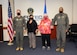 The Air Force Operational Test and Evaluation Center, Detachment 5, commander, Col. Glenn Rineheart, and senior enlisted leader, Senior Master Sgt. Brian Pettaway, congratulate teammates Elida Narciso and Brenda Johnston after receiving a special award for their actions resulting in saving a fellow team member's life, at Edwards Air Force Base, California, Dec. 3. (Air Force photo by Giancarlo Casem)