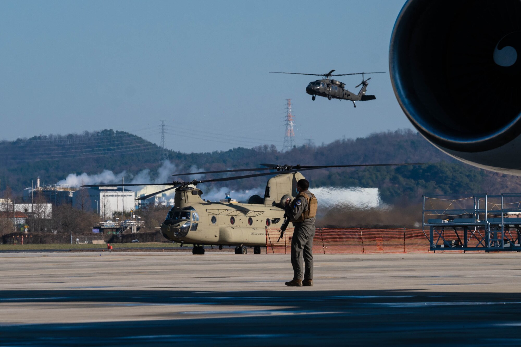 Lloyd J. Austin III, United States Secretary of Defense, arrives by HH-60 Black Hawk helicopter to board a departing aircraft at Osan