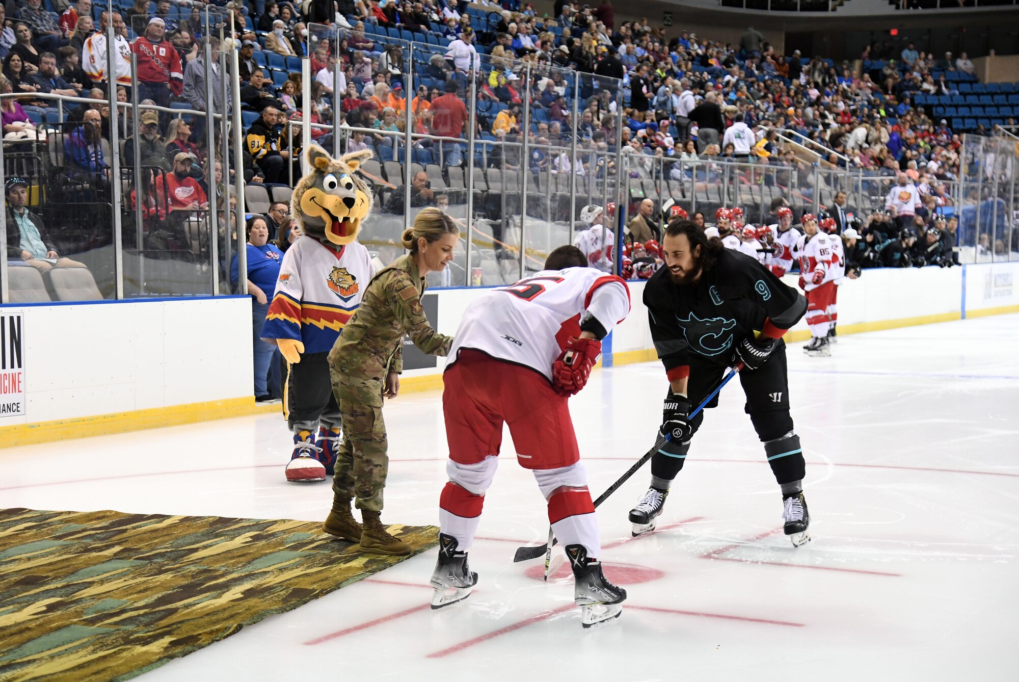 U.S. Air Force Maj. Gen. Michele Edmondson, Second Air Force commander, participates in a ceremonial puck drop during the Biloxi Pro Hockey game inside the Mississippi Coast Coliseum at Biloxi, Mississippi, Dec. 2, 2021. The Keesler Air Force Base Honor Guard and 81st Training Wing leadership also participated in pre-game festivities. (U.S. Air Force photo by Kemberly Groue)