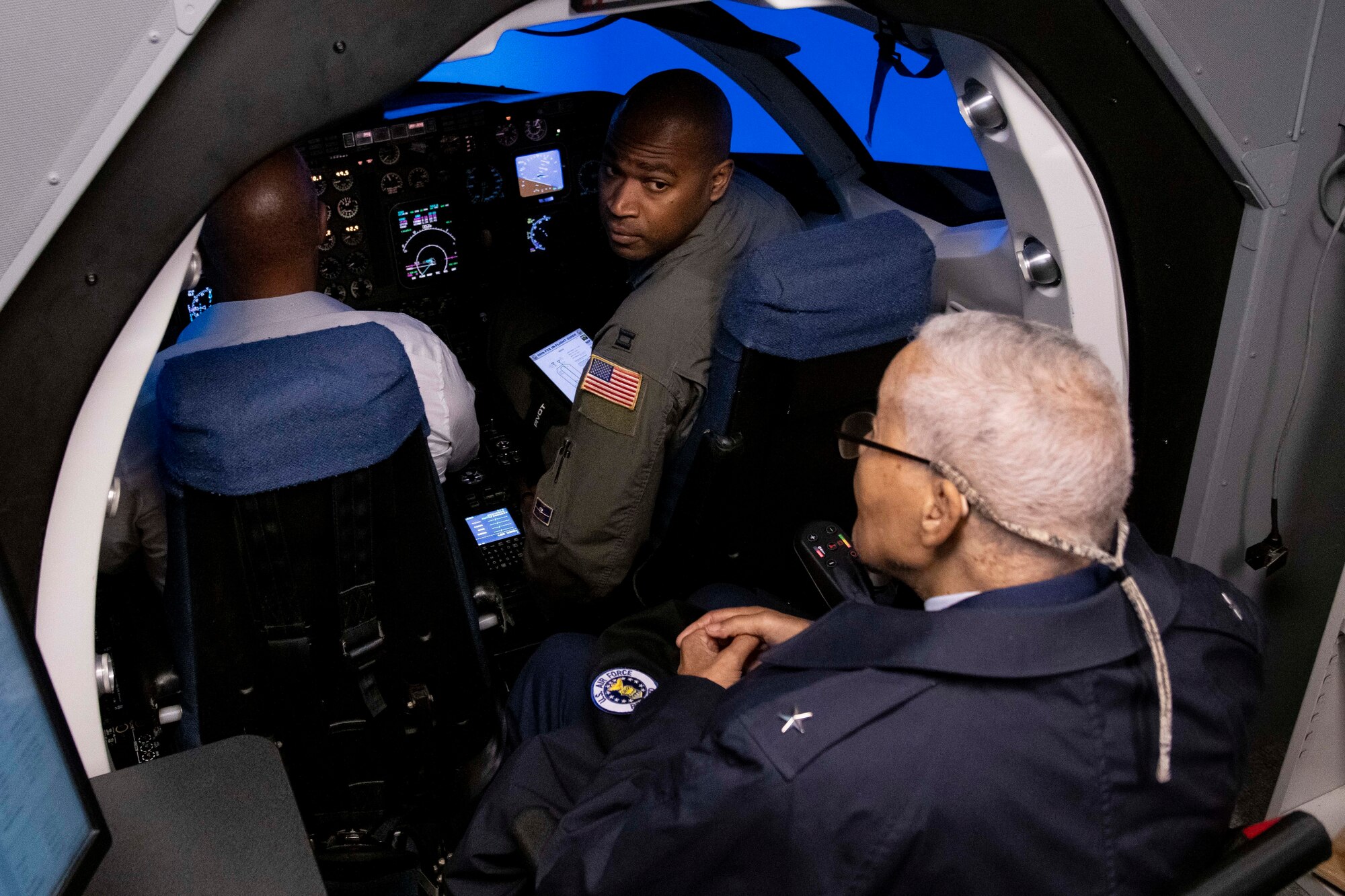 Military pilots in a flight simulator.