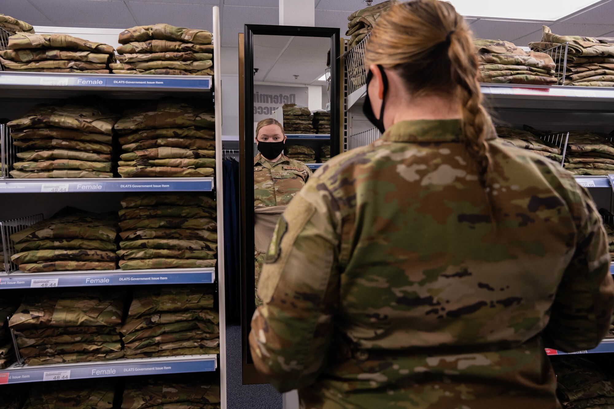 Senior Airman Quynn Santjer, unit deployment manager for the 94th Fighter Squadron, looks through the new abundance of maternity options at Military Clothing Sales at Joint Base Langley-Eustis, Va., Dec. 2, 2021. Santjer was happy to know that her co-worker, who is newly pregnant, will not have to wait for uniforms to be shipped to her like she did.