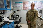 An Airman poses for a photo in the lab.