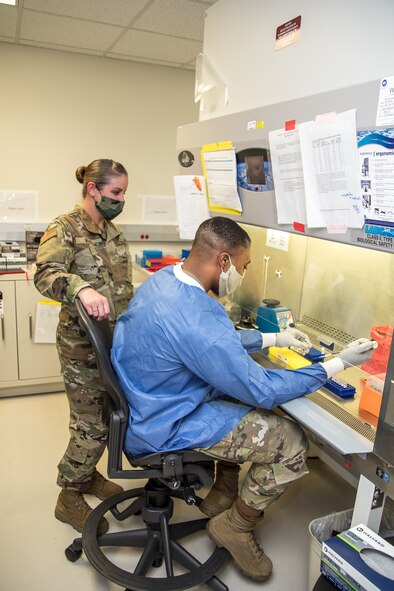 Airmen prepare patient samples for COVID-19 extraction at BAMC.