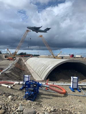Construction on the single-span concrete arch, that replaced the two steel pipe culverts, at Joint Base Lewis-McChord Airfield, Tacoma, Washington.
