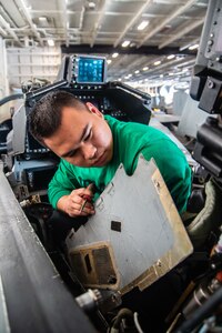 Aviation Structural Mechanic 2nd Class Liam Roque, from Simi Valley, California, assigned to the “Red Rippers” of Strike Fighter Squadron (VFA) 11, inspects an eletrical panel in the cockpit of an F/A-18E Super Hornet in the hangar bay of the Nimitz-class aircraft carrier USS Harry S. Truman (CVN 75).