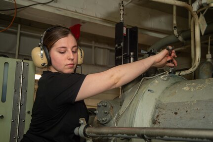 Aviation Boatswain's Mate (Equipment) Airman Sierra Smith, from Surprise, Arizona, monitors arresting gear cable systems aboard the Nimitz-class aircraft carrier, USS Harry. S Truman (CVN-75).