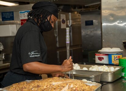Culinary Specialist Seaman Kartia Thompson, from Anderson, South Carolina, prepares egg salad in a galley aboard the Nimitz-class aircraft carrier USS Harry S. Truman (CVN 75).