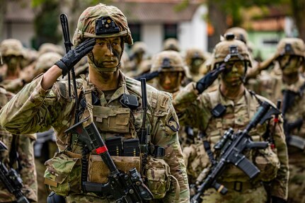 U.S. Army Soldiers assigned to Bravo Company, 1st Battalion, 187th Infantry Regiment, 3rd Brigade Combat Team (Rakkasan), 101st Airborne Division (Air Assault) salute during the opening ceremony of Southern Vanguard 22 at the 5th Light Infantry Battalion in Lorena, Brazil, Dec. 6 2021. Southern Vanguard 22 was planned as a 10-day air assault operation and was the largest deployment of a U.S. Army unit to train with the Brazilian army forces in Brazil. (U.S Army photo by Pfc. Joshua Taeckens)