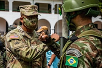 U.S. Army South Commanding General, Gen. William Thigpen, greets a Brazilian army soldier during the opening ceremony of Southern Vanguard 22 at the 5th Light Infantry in Lorena, Brazil, Dec. 6, 2021. Battalion Southern Vanguard 22 was planned as a 10-day air assault operation and was the largest deployment of a U.S. Army unit to train with the Brazilian army forces in Brazil. (U.S Army photo by Pfc. Joshua Taeckens)