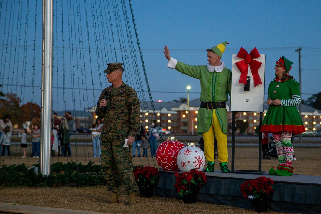 U.S. Marine Corps Col. Mikel Huber, commanding officer of Marine Corps Air Station (MCAS) Cherry Point, speaks to service members and their family members before beginning the countdown during the annual tree lighting ceremony at Marine Corps Air Station Cherry Point, North Carolina, Dec. 3, 2021. This event featured live music from the 2nd Marine Aircraft Wing Band, a holiday selfie station, and free cookies and hot cocoa. (U.S. Marine Corps photo by Lance Cpl. Jacob Bertram)