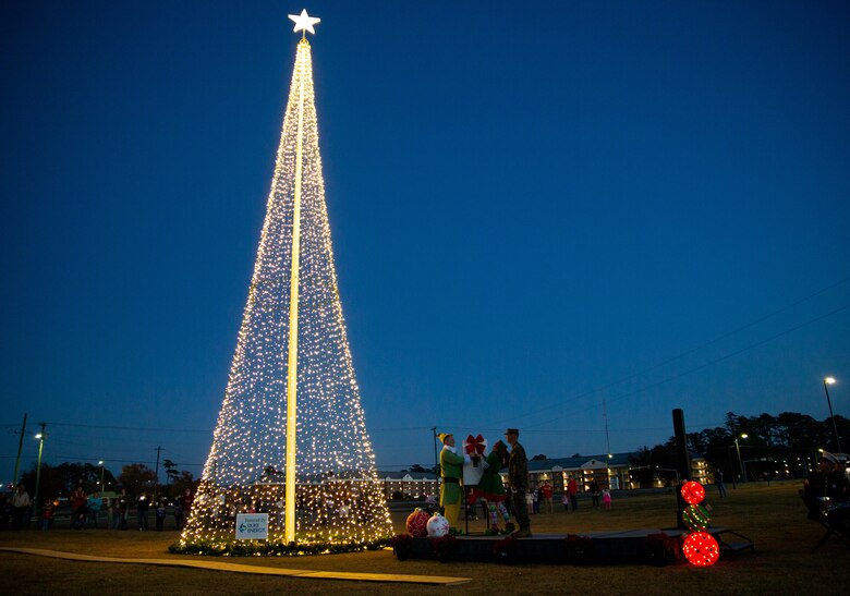 U.S. Marine Corps Col. Mikel Huber, commanding officer of Marine Corps Air Station (MCAS) Cherry Point, watches as the Christmas tree is flipped on during the annual tree lighting ceremony at Marine Corps Air Station Cherry Point, North Carolina, Dec. 3, 2021.