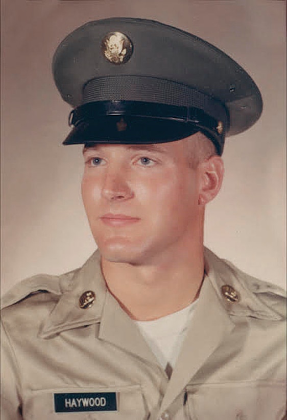 A soldier poses for a photo.