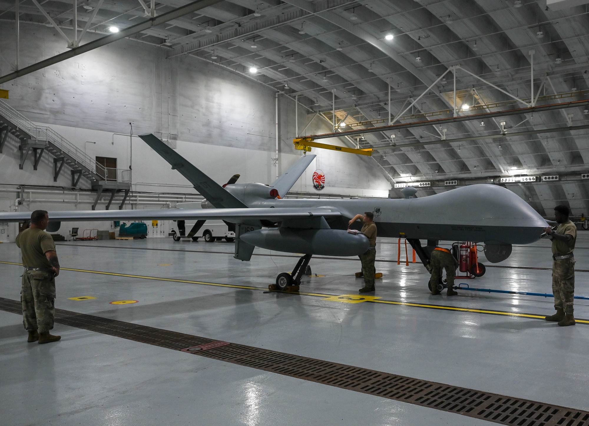 Airmen from the 556th Test and Evaluation Squadron preflight a MQ-9 Reaper at Andersen Air Force Base, Guam, Oct. 4, 2021. The Reaper was flown from Marine Corps Base, Hawaii, during its participation in Exercise Ace Reaper.  The purpose of ACE Reaper is to demonstrate the MQ-9’s capabilities and service members’ abilities to rapidly mobilize and integrate across multiple domains. The exercise also serves as an opportunity to train in a maritime environment and in a different airspace. (U.S. Air Force photo by Staff Sgt. Divine Cox)