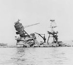 The battleship USS Arizona (BB-39), modernized at NNSY from 1929 to 1931, was destroyed during the Dec. 7, 1941 attack on Pearl Harbor.  An 1,800-pound bomb triggered a massive explosion and sunk the ship with more than 1,000 crewmembers trapped inside. This photo shows the Arizona three days after the attack.