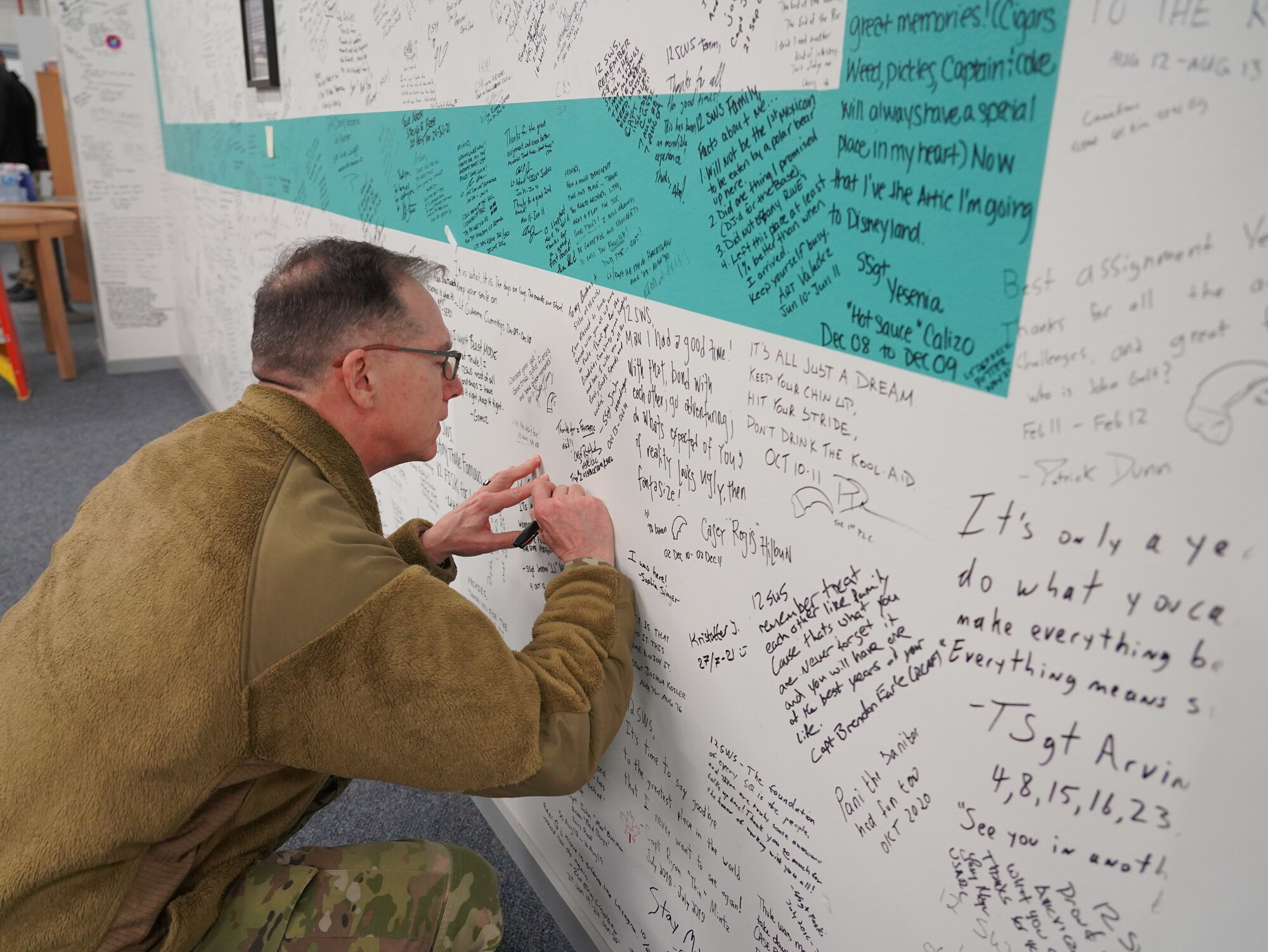 Man signing wall