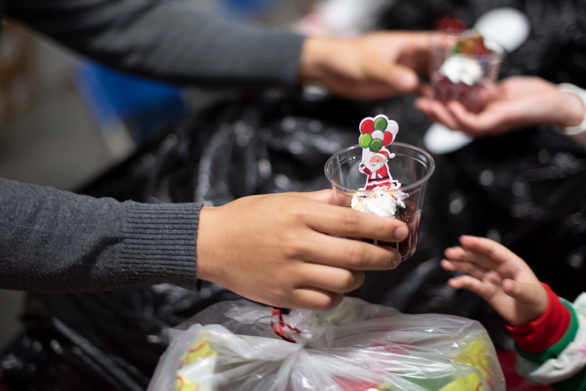 Photos of an event where families got to meet, take a photo with, and receive gifts from Santa Claus.