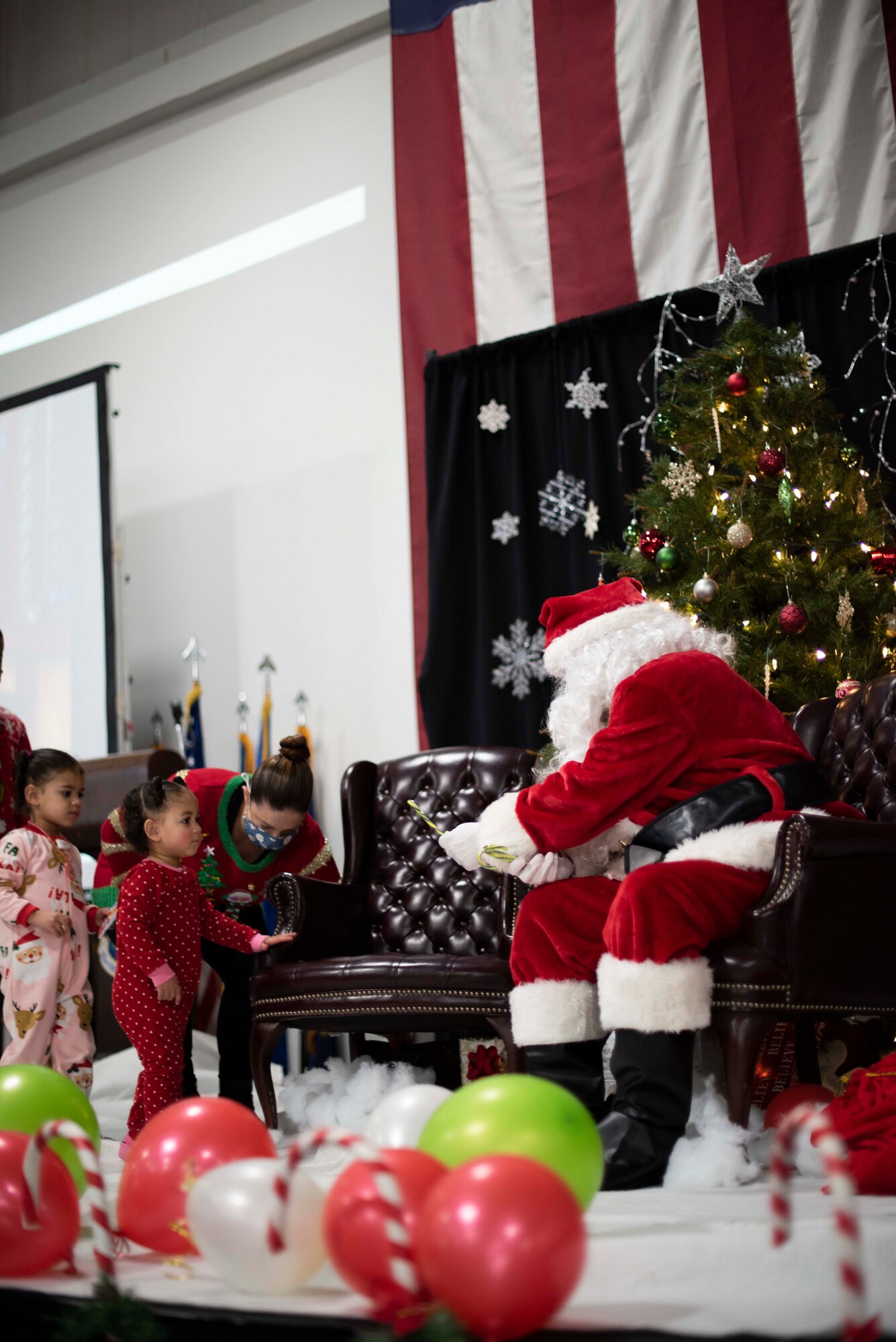Photos of an event where families got to meet, take a photo with, and receive gifts from Santa Claus.