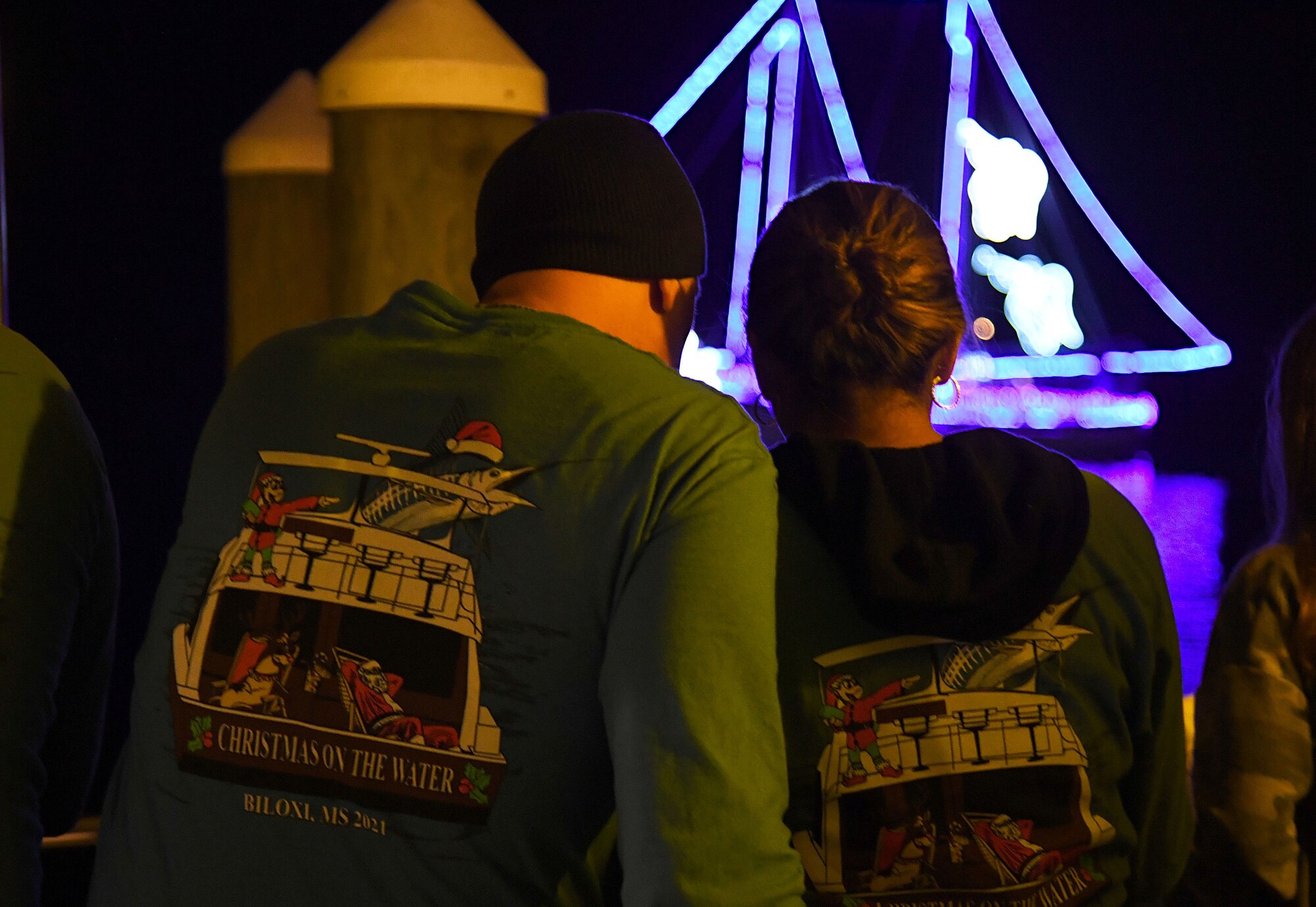 U.S. Air Force Col. William Hunter, 81st Training Wing commander, and his wife, Blanca, write down scores during the 36th Annual Christmas on the Water Boat Parade in Biloxi, Mississippi, Dec. 4, 2021. Keesler Air Force Base leadership judged more than 25 boats during the annual holiday event. (U.S. Air Force photo by Kemberly Groue)