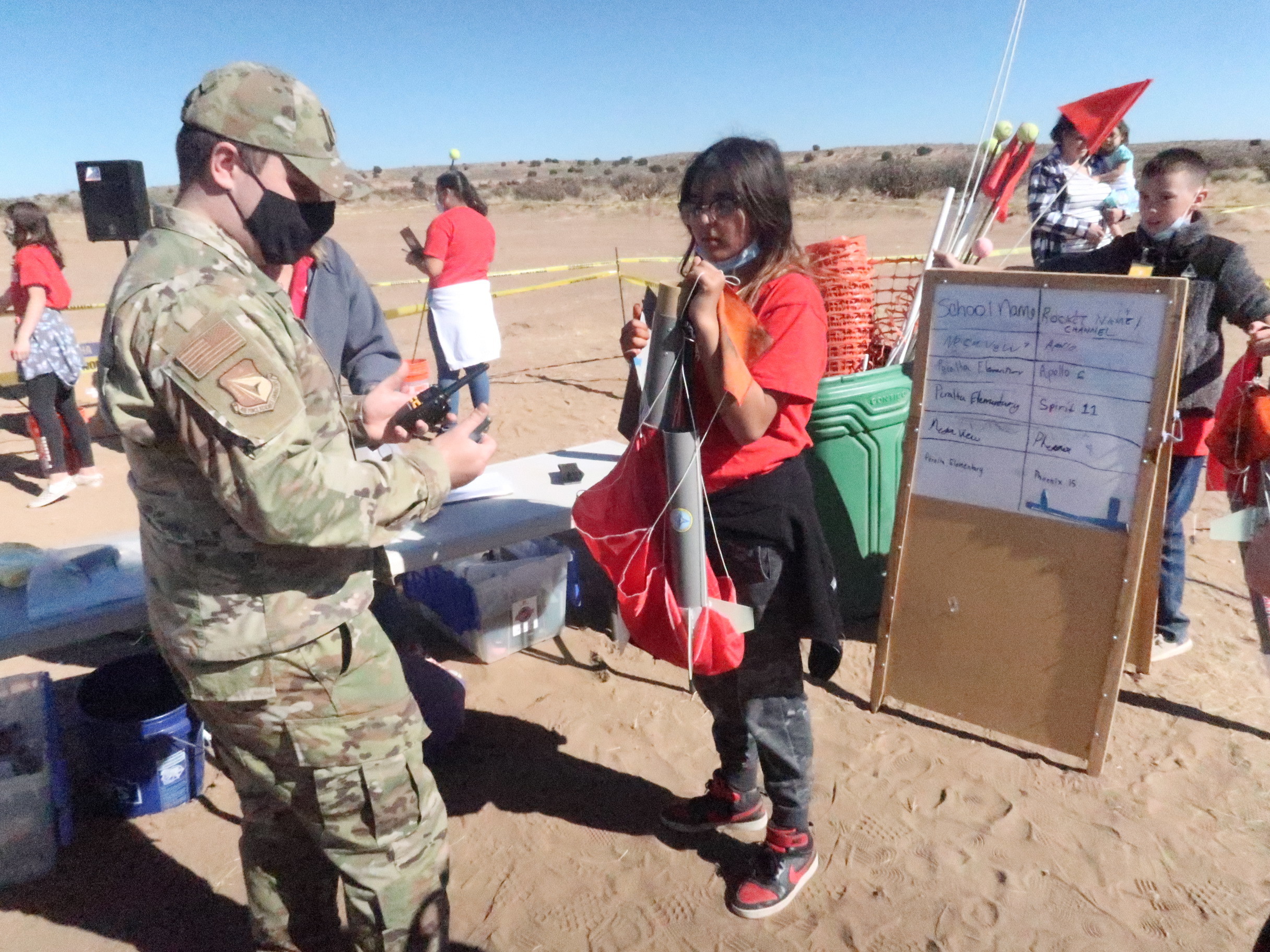 Air Force Research Laboratory’s STEM Academy holds a rocket launch for Albuquerque area students. AFRL 1st Lt. Caleb Sapp advises a student on her team’s rocket. (U.S. Air Force photo/Stephen Burke)