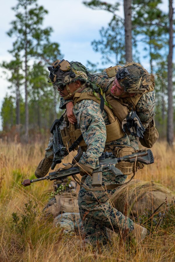 U.S Marine Corps Cpl. William Abelt, a rifleman with 3rd Battalion, 2d Marine Regiment, 2d Marine Division, carries a casualty during a mass casualty drill as part of a Marine Corps Combat Readiness Evaluation (MCCRE) on Camp Lejeune, N.C., Dec. 4, 2021.