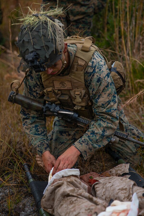 U.S. Marine Corps Lance Cpl. Kevin Lewallen, a rifleman with 3rd Battalion, 2d Marine Regiment, 2d Marine Division, stabilizes a simulated casualty during a mass casualty drill as part of a Marine Corps Combat Readiness Evaluation (MCCRE) on Camp Lejeune, N.C., Dec. 4, 2021.